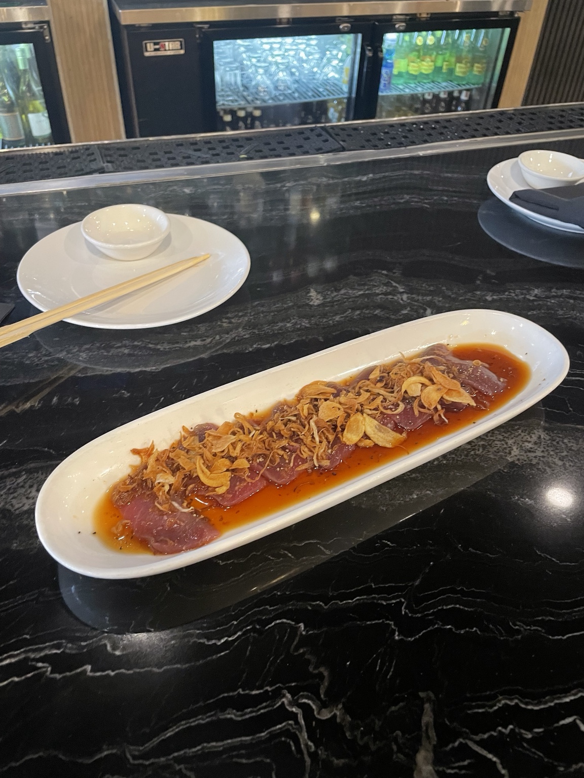 Truffle Tuna with crispy garlic, citrus sauce, and crispy onions at Suxico Sushi